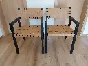 Olivier de SCHRIJVER, (1958), Paire de fauteuils "Boss", bois noirci et lanières de cuir, 53 x 53 x 83 cm, signés et numérotés 15 et 16 /240.